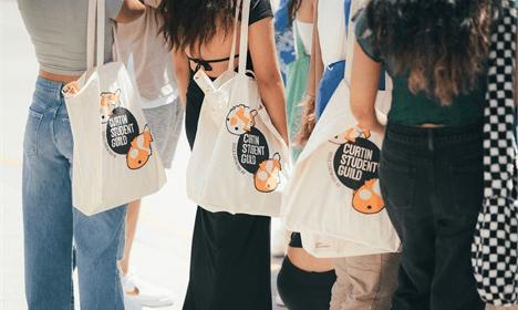 Students carrying Curtin Student Guild tote bags