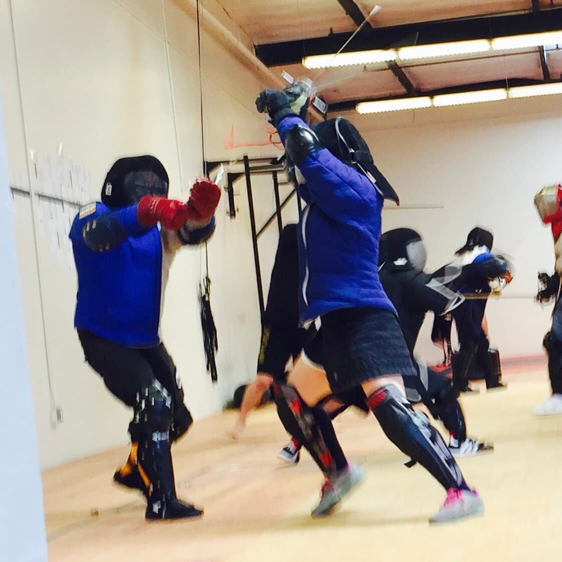 HEMA practitioners sparring in full protective gear